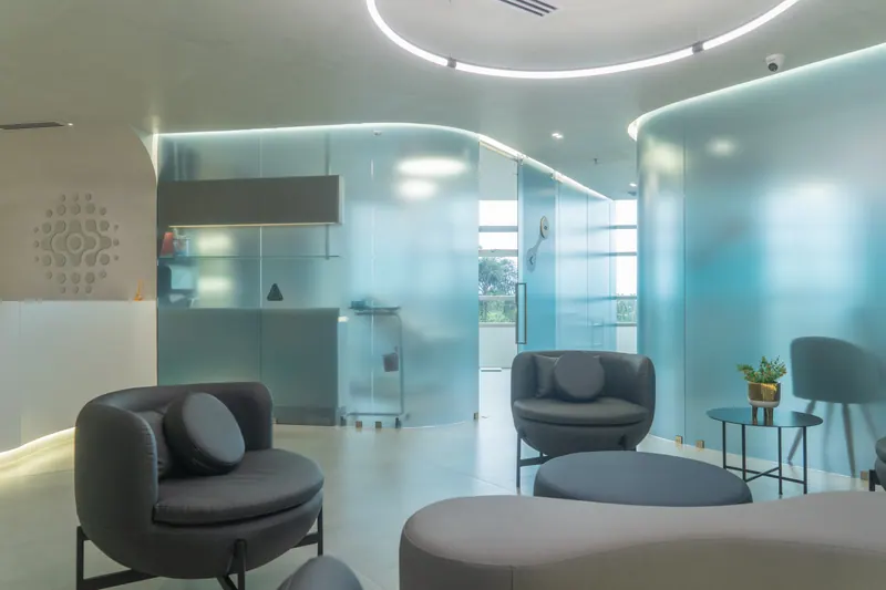 Patient waiting area with circular LED ceiling light and rounded lounge chairs